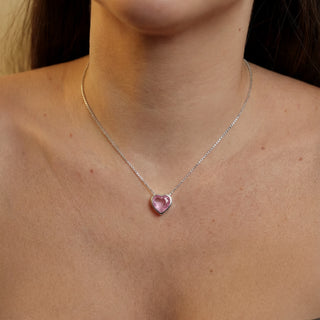 Colar com zircônia de coração roxo banhado a prata 925 da UNA Semijoias e Aço no colo feminino em close, com pingente de coração em destaque ao centro.
